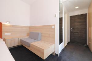 a sauna with a bench in a room with a door at Hotel Mediteran in Zadar