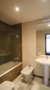 a bathroom with a sink and a toilet and a tub at Laplaya Apppart Hotel in Tangier