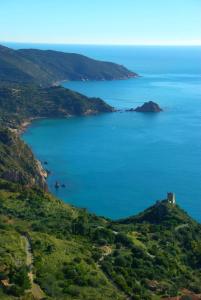 an island in the ocean with a castle on a hill at PENSIONE VERDE LUNA in Orbetello