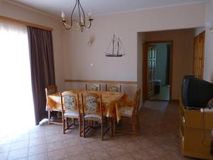 a dining room with a table with chairs and a boat on the wall at Holiday Home Scamard in Zamárdi