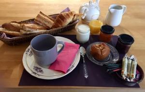 a table with a plate of bread and a cup of coffee at Troglodytes "Loire Sauvage" in Rochecorbon
