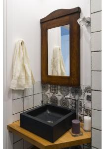 a black sink in a bathroom with a mirror at Gostynin Garden Apartment in Gostynin +25 photos