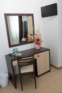 a desk with a mirror and a chair in a room at PARCO DELLE STELLE in Castelmauro