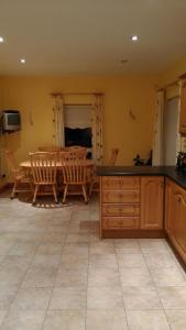 a kitchen and dining room with a table and chairs at Warm and welcoming family home in Ballinrobe
