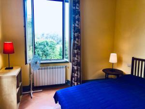a bedroom with a blue bed and a large window at Villachiara in Silvi Marina