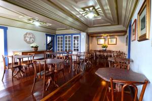 a dining room with wooden tables and chairs at Hotel Pousada Casa Grande in Ouro Preto