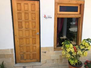 a wooden door and a mirror in front of a building at San Jose Olympia in San Cristóbal de Las Casas