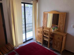 a bathroom with a wooden dresser and a mirror at San Jose Olympia in San Crist&oacute;bal de Las Casas