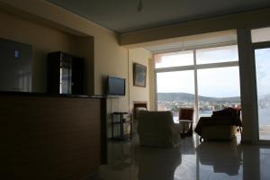 a living room with two chairs and a large window at Mousonette in Selínia