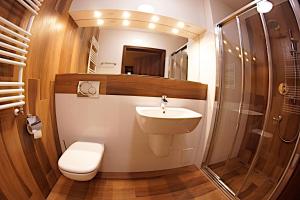 a bathroom with a toilet and a sink and a shower at Hotel Neo Międzyrzecz in Międzyrzecz +35 photos