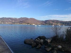 a view of a lake with rocks in the water at The Horse in Pogno