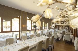 a dining room with white tables and chairs at Hotel de la Poste - Relais de Napoleon III in Bouillon