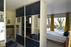a bedroom with a large glass wall at suite indépendante au calme avec piscine in Aix-en-Provence