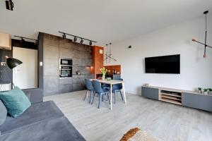 a living room with a couch and a table at The Scandic Suite Sopot-Gdynia Apartment in Gdynia