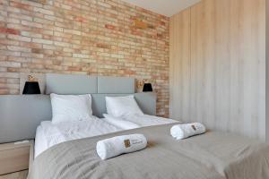 a bedroom with a bed with two pillows on it at The Scandic Suite Sopot-Gdynia Apartment in Gdynia