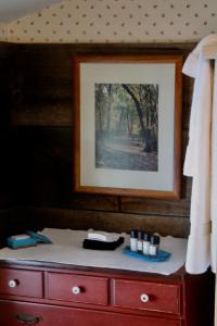 a dresser with a picture on top of it at Sugar Hill Inn in Sugar Hill