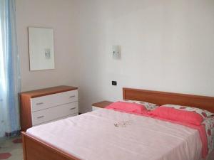 a bedroom with a bed and a dresser in it at Brezza Marina in Portovenere