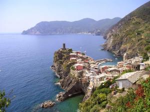 a small village on a cliff in the water at Brezza Marina in Portovenere