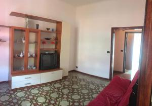 a living room with a tv on a cabinet at Brezza Marina in Portovenere