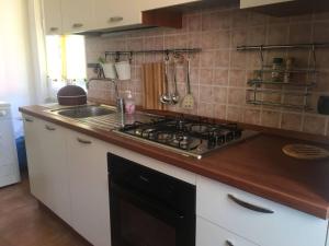 a kitchen with a stove and a sink at Brezza Marina in Portovenere