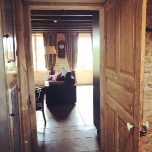 a hallway with a living room with a couch at La Grosse Talle in Sepvret