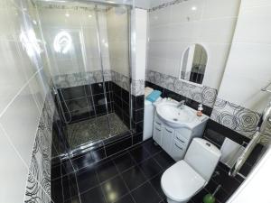 a bathroom with a shower and a toilet and a sink at Apartment Grand Kazan on Chistopolskoi 79 in Kazan