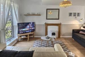 a living room with a couch and a tv at 52 Minster in Beverley