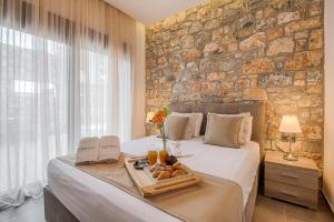 a bed with a tray of food on it at Prasonisi Villas in Kattavía