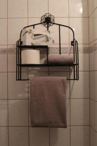 a bathroom with three shelves with towels and a sink at Hotel Restaurant Bürgerstube in Ulmen +94 photos