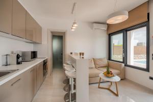 a kitchen and living room with a couch and a table at Prasonisi Villas in Kattavía