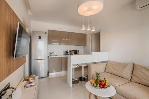 a living room with a couch and a table with fruit on it at Prasonisi Villas in Kattavía