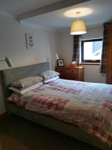 A bed or beds in a room at The Greannan Lower Self catering apartment