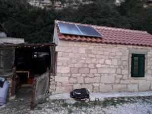 a building with a solar panel on top of it at Holiday home Stiniva in Vis