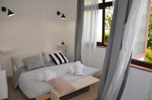 Un pat sau paturi într-o cameră la Ilgiardinodilina
