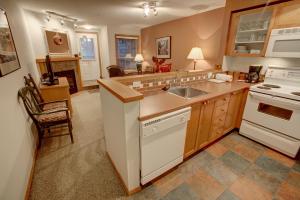a kitchen with a sink and a stove at Glacier's Reach in Whistler