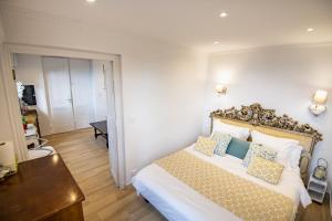 a bedroom with a bed and a table and a door at La Bella Vista in Roquebrune-Cap-Martin