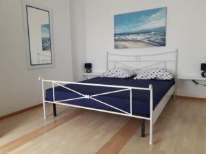a bedroom with a bed with blue sheets and pillows at Lana Apartments in Trogir