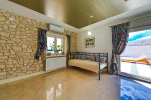 a living room with a stone wall and a couch at Villa AnBer in KoruÅ¡ce +86 photos
