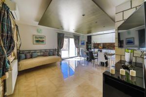 a living room with a couch and a dining room at Villa AnBer in KoruÅ¡ce