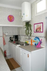 a kitchen with a sink and a counter top at Casa da Marcos de Portugal in Lisbon