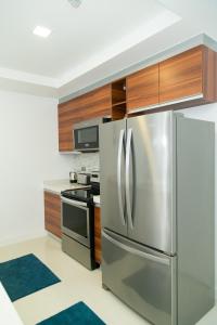 a kitchen with a stainless steel refrigerator and wooden cabinets at Elegance at 20 South in Kingston