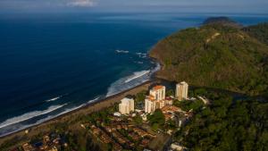 eine Luftansicht eines Resorts am Meer in der Unterkunft The Palms Ocean Club Resort in Jacó