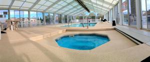 a swimming pool in a building with a glass ceiling at Aquarius Inn in Bicknell