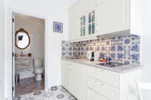 a bathroom with a sink and a toilet in it at CASA DO PESCADOR by Ammonite&Co in Olhão