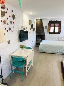 a bedroom with a bed and a desk and a table at Heart of Gracia in Barcelona