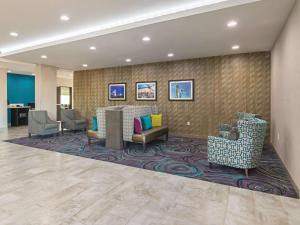 a lobby with couches and chairs on a rug at La Quinta by Wyndham Dallas - Wylie in Wylie