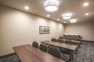 a conference room with tables and chairs and lights at La Quinta by Wyndham Dallas Northeast-Arboretum in Garland +27 photos