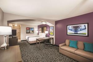 a hotel room with a bed and a desk at La Quinta by Wyndham Walker - Denham Springs in Walker