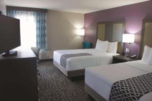 a hotel room with two beds and a flat screen tv at La Quinta by Wyndham Kanab in Kanab