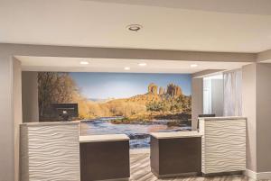 
a living room with a painting on the wall at La Quinta by Wyndham Flagstaff in Flagstaff
